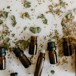 Flat lay of brown glass bottles and dried herbs, perfect for aromatherapy themes.