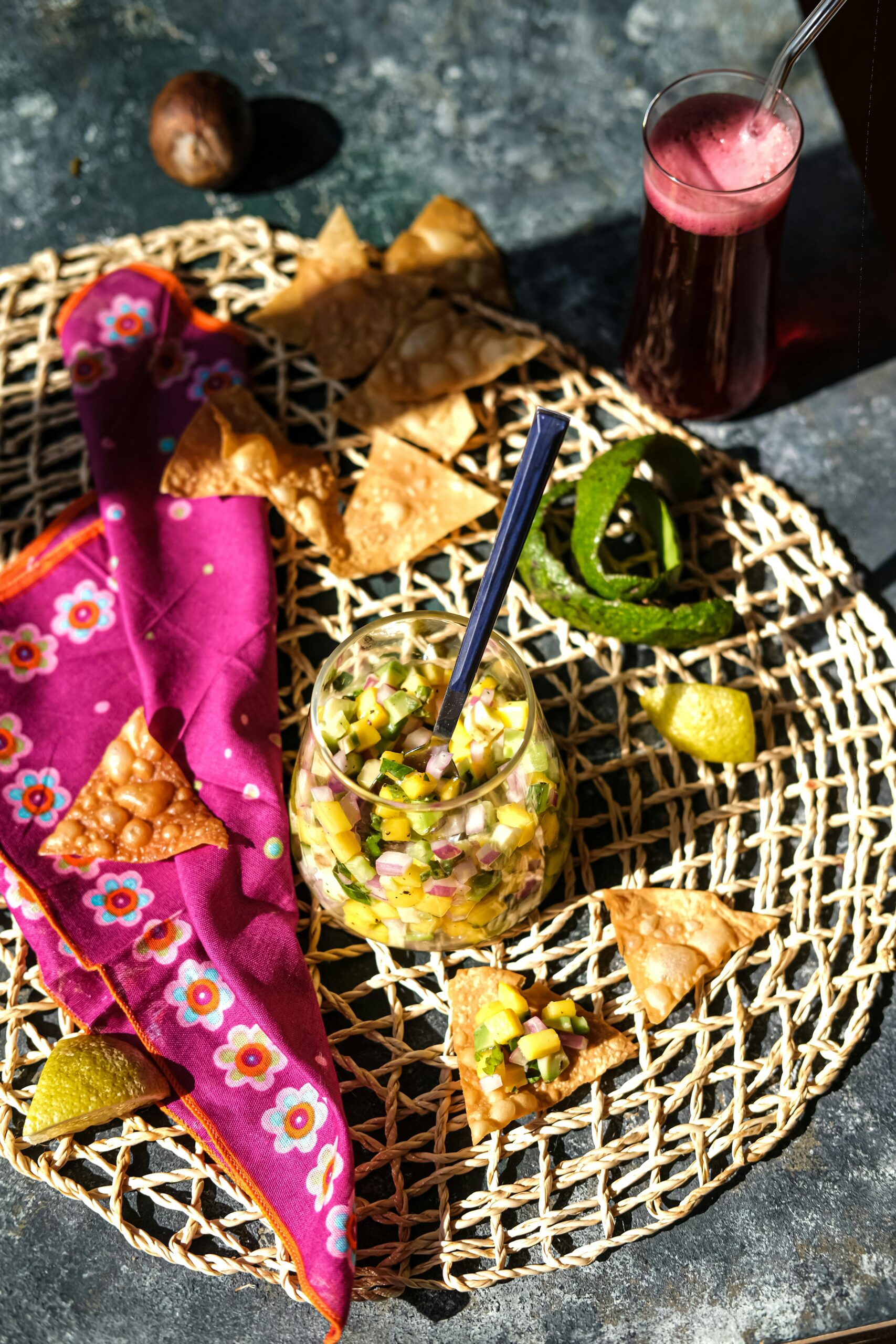 Top view of fresh salsa with chips and beet juice, filled with vibrant colors.